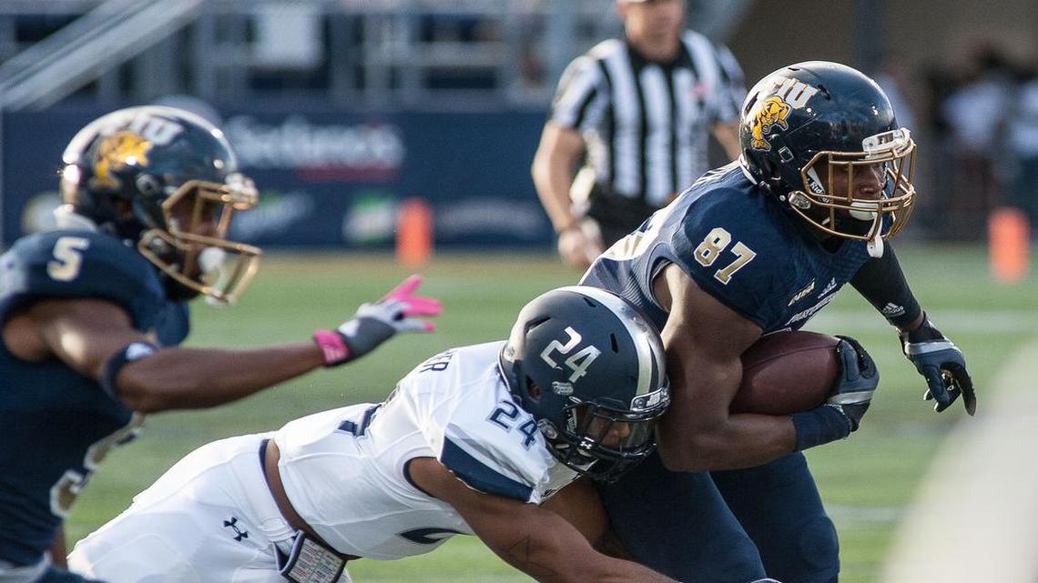 Strong safety Fellonte Misher (24) tackles tide end Jonnu Smith (87) in the college football game between the Florida International Golden Panthers and Old Dominion University at Ocean Bank Field at FIU in Miami, Fla Saturday evening Oct. 24, 2015.