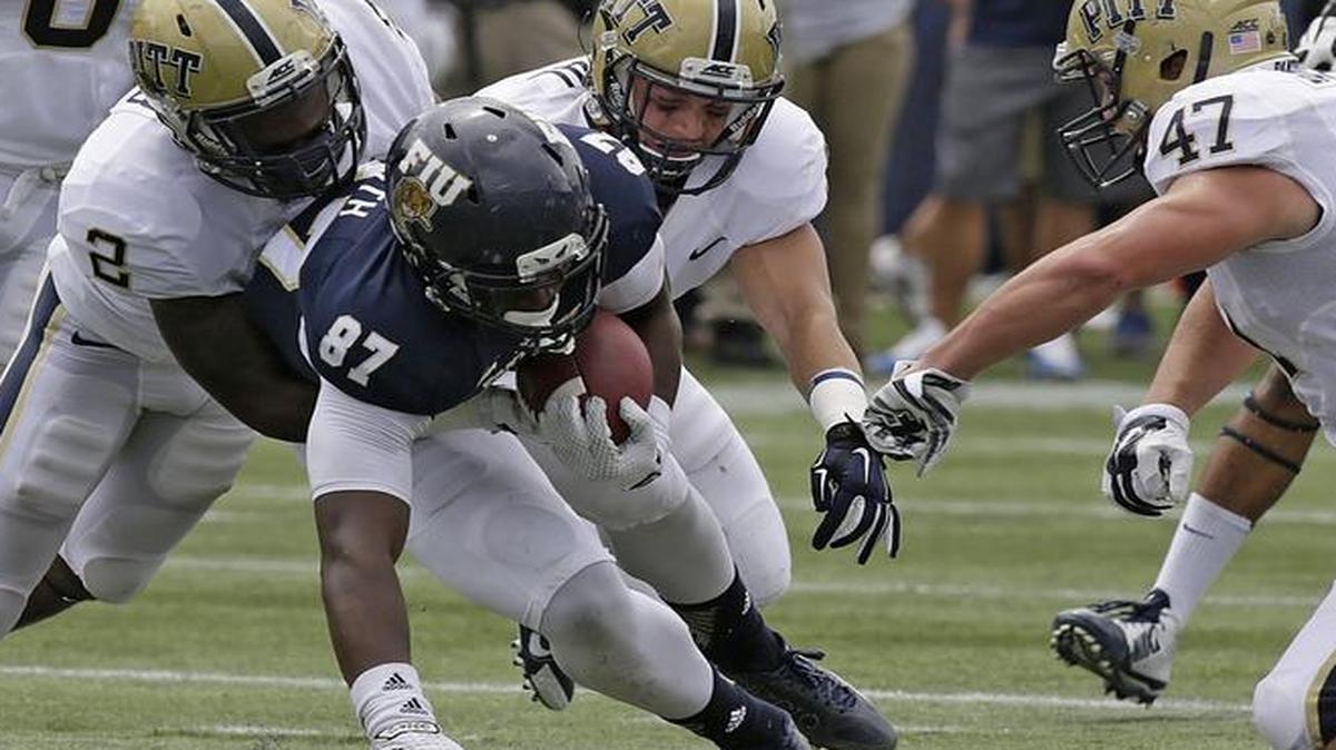 
FIU tight end Jonnu Smith (87) tries to escape a tackle by Pittsburgh defenders Saturday, Sept. 13, 2014 at Ocean Bank Field at FIU Stadium. 
