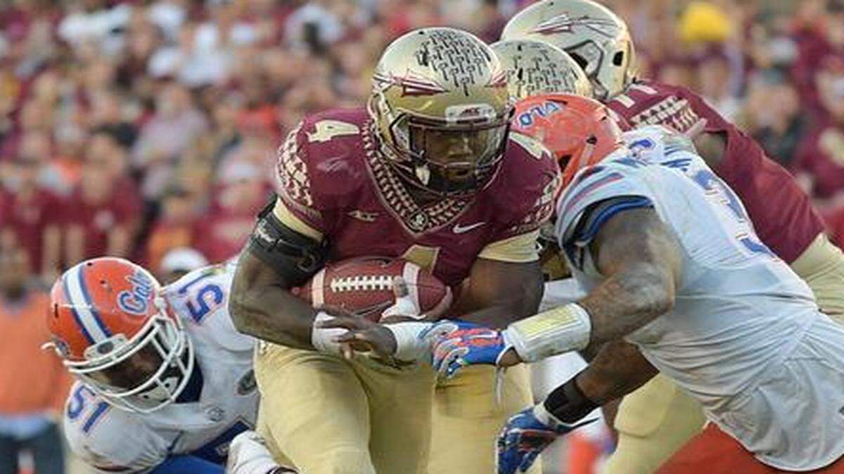 
Florida State running back Dalvin Cook runs for some of his 144 yards on 24 carries that helped the Seminoles hold off Florida on Saturday at Doak Campbell Stadium.
