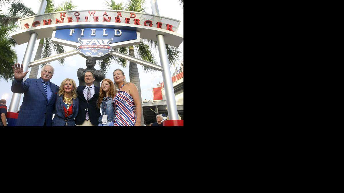 
From left: Former FAU coach Howard Schnellberger, left, is joined by his wife Beverlee, FAU President John Kelly and his daughter Carly and wife Carolyn at the dedication of the field at FAU Stadium, now named after Howard Schnellberger before the start of the team’s game against the University of Tulsa on Sept. 13, 2014.
