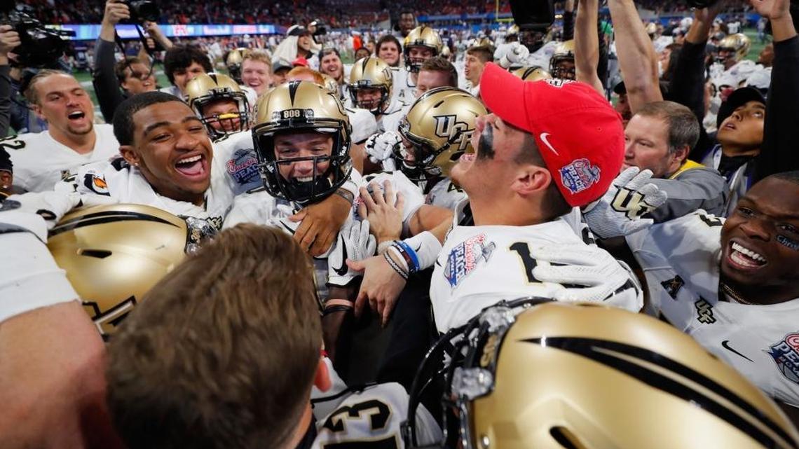 The UCF Knights celebrate defeating the Auburn Tigers 34-27 to win the Chick-fil-A Peach Bowl at Mercedes-Benz Stadium on Jan. 1, 2018, in Atlanta.