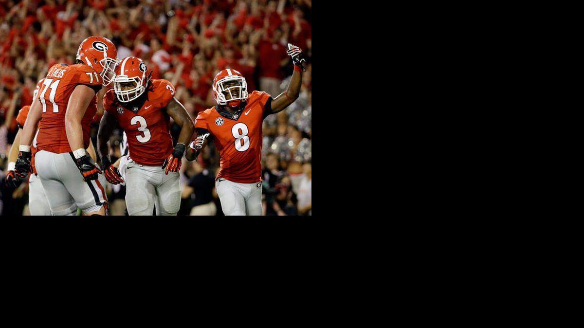 
Georgia running back Todd Gurley (3) celebrates with teammates after scoring in the second half of an NCAA college football game against Clemson, Saturday, Aug. 30, 2014, in Athens, Ga.
