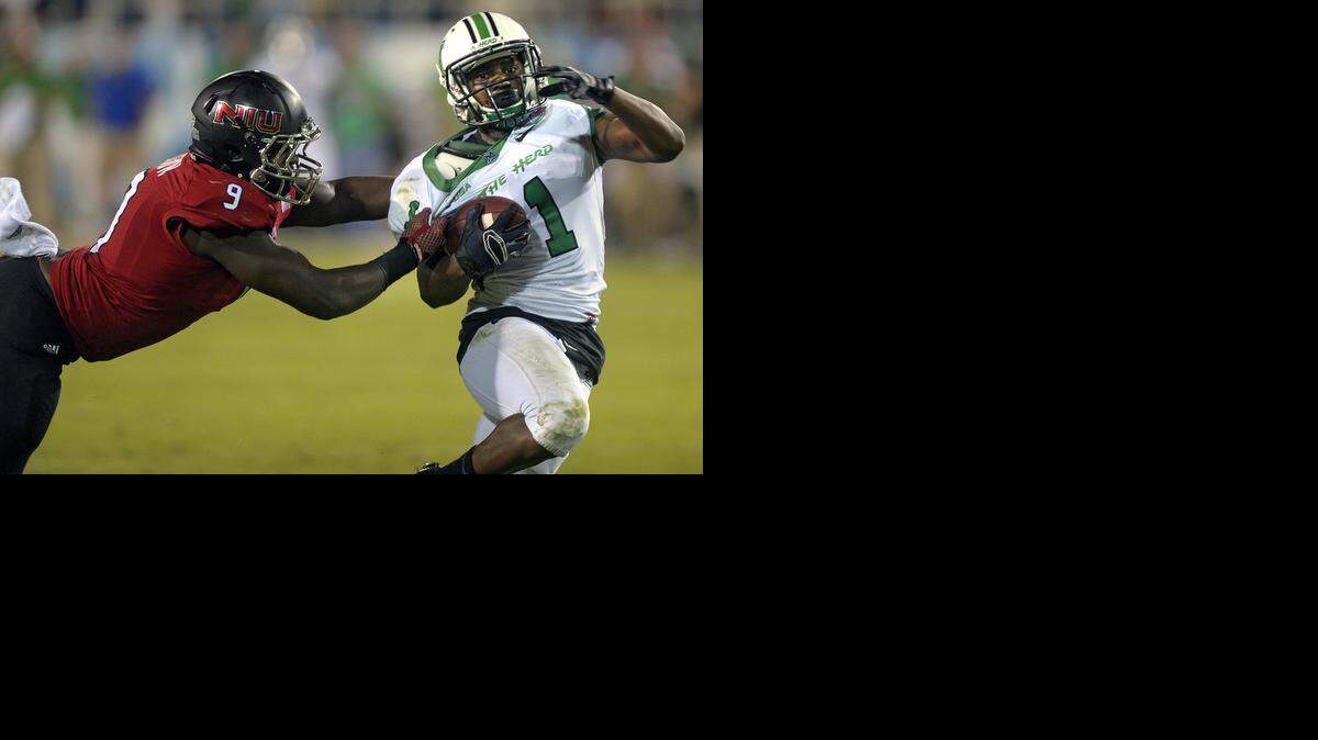 
Marshall receiver Tommy Shuler is tackled short of the goal line by Northern Illinois University linebacker Rasheen Lemon during the first half of the Boca Raton Bowl at FAU Stadium on Dec. 23, 2014.
