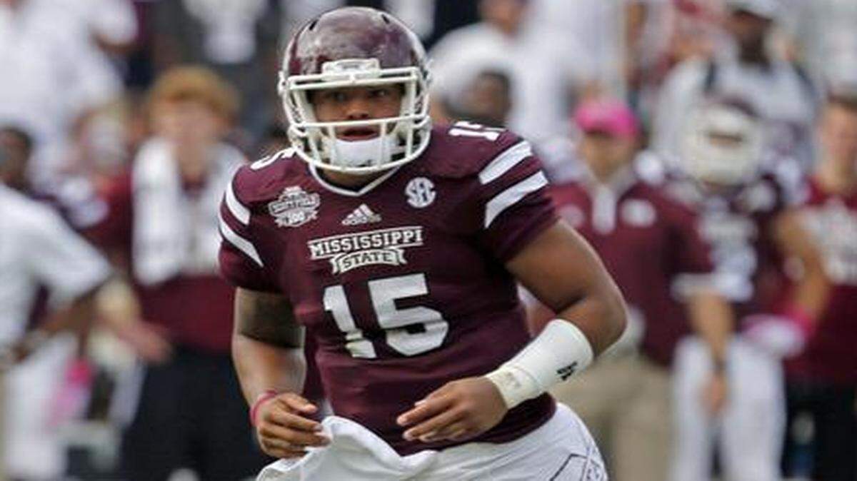 
Mississippi State quarterback Dak Prescott (15) runs across the field during a game against Auburn in Starkville, Miss., Saturday, Oct 11, 2014. 
