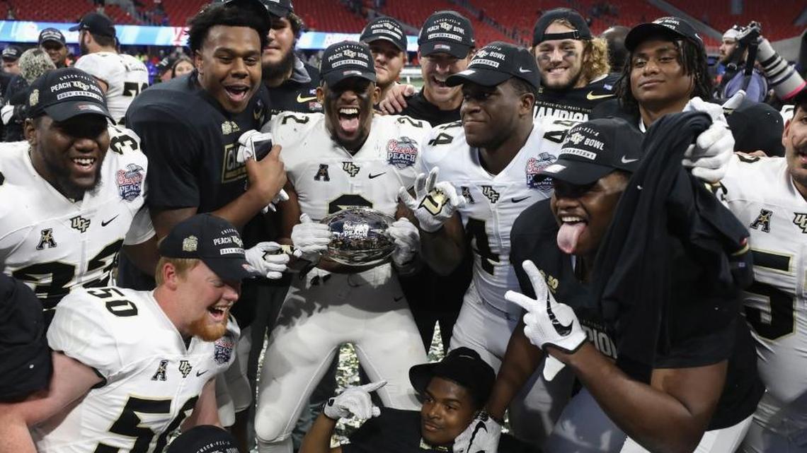 The UCF Knights celebrate defeating the Auburn Tigers 34-27 to win the Chick-fil-A Peach Bowl at Mercedes-Benz Stadium on Jan. 1, 2018, in Atlanta. UCF went undefeated this season.