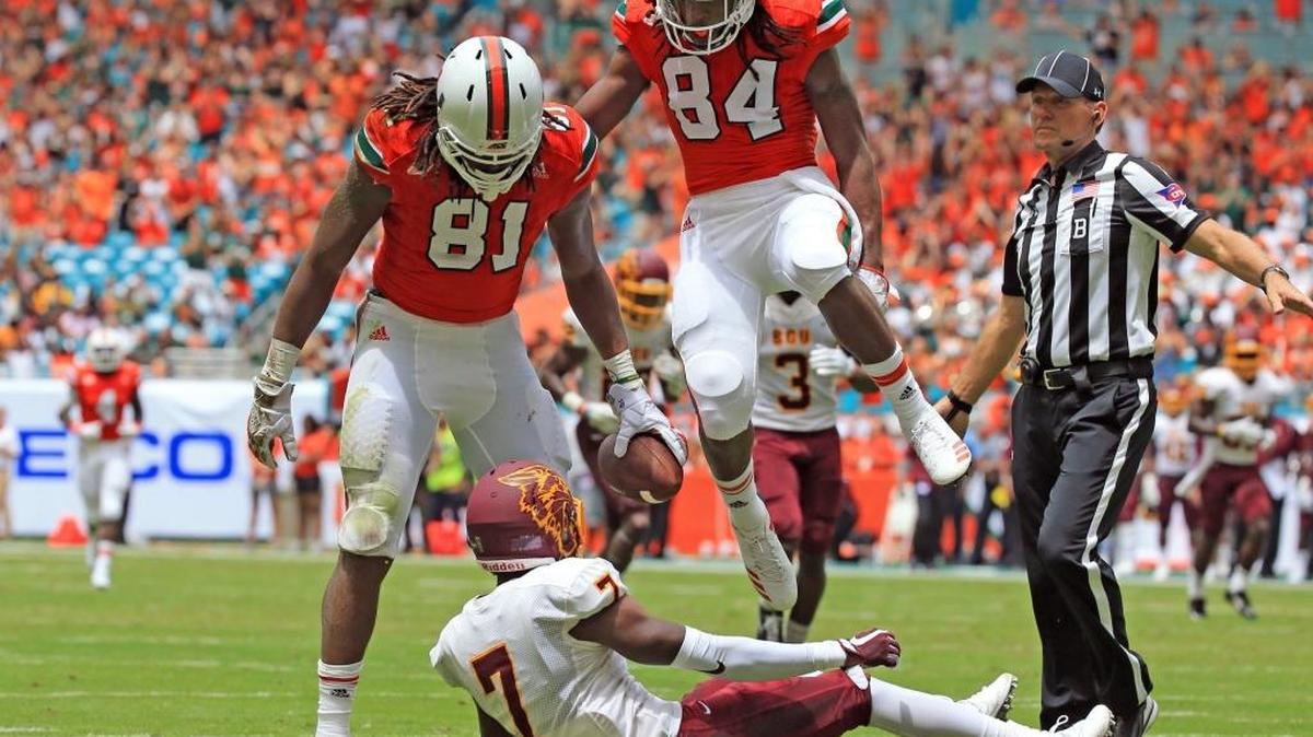 Hurricanes wide receiver Darrell Langham (81) celebrates over Bethune-Cookman cornerback Elliott Miller (7) after a long reception in the second quarter of Saturday’s season-opening 41-13 UM win at Hard Rock Stadium.