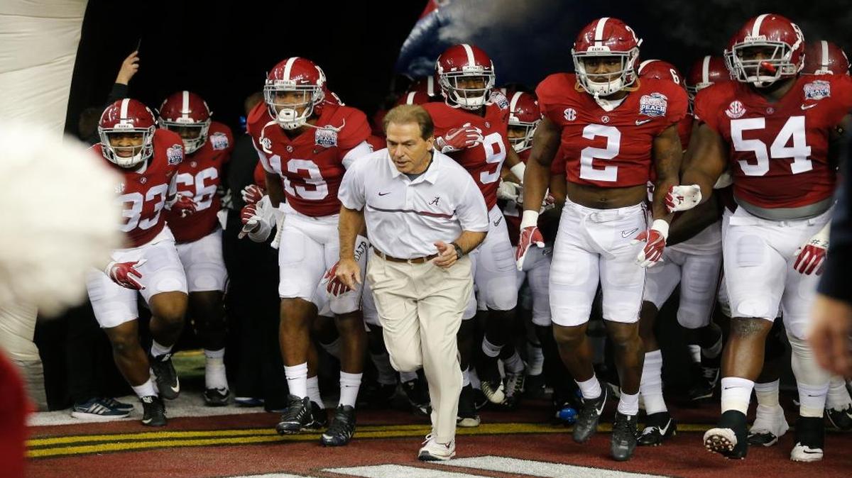 Alabama head coach Nick Saban and team enter the field the first half of the Peach Bowl NCAA college football playoff game between Alabama and Washington, Saturday, Dec. 31, 2016, in Atlanta.