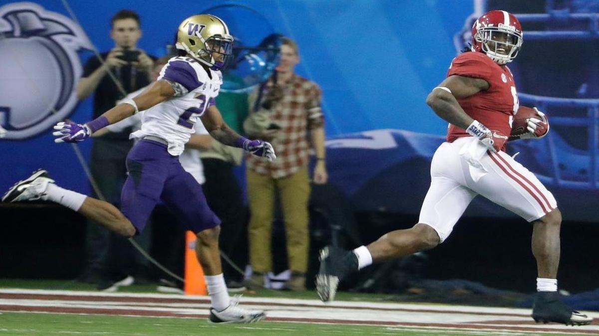Alabama running back Bo Scarbrough (9) looks back as he runs for a touchdown against Washington defensive back Kevin King (20) during the second half of the Peach Bowl NCAA college football playoff game, Saturday, Dec. 31, 2016, in Atlanta.