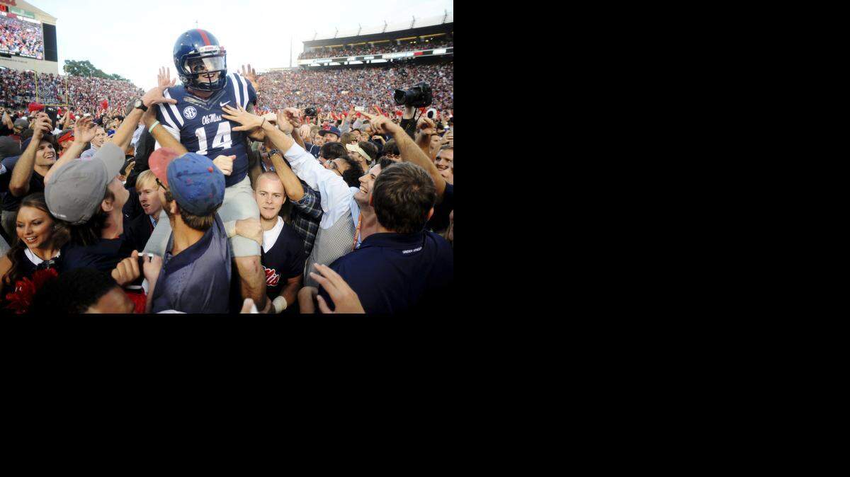 
Mississippi quarterback Bo Wallace (14) is carried off the field by fans following their 23-17 win over No. 3 Alabama in Oxford, Miss., Saturday, Oct. 4, 2014. 
