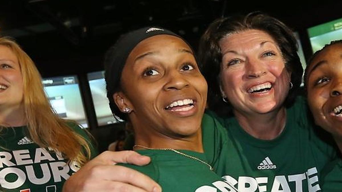 University of Miami head basketball coach Katie Meier (center) celebrate with players Adrienne Motley and Jessica Thomas and their teamamtes on Monday, March 13, 2017 as they realize they will be playing at home in the NCAA Tournament.
