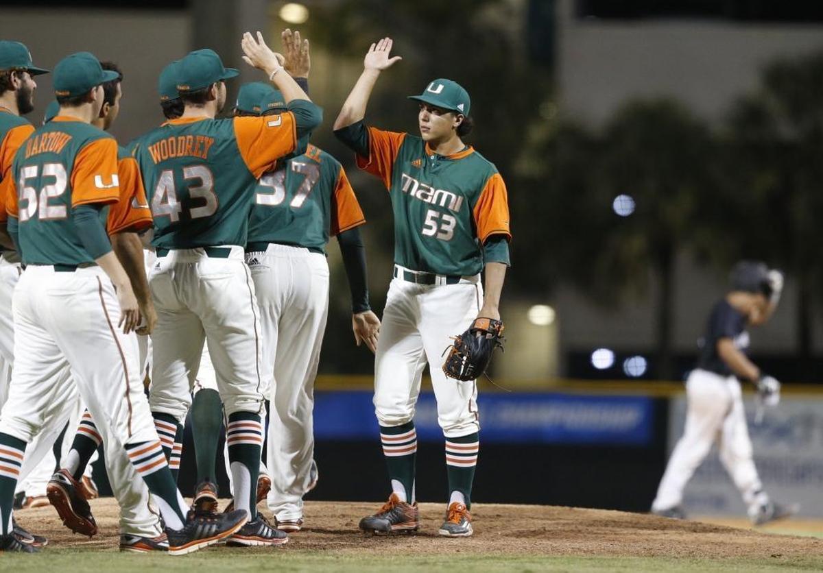 Miami pitcher Andrew Cabezas (53) and teammates celebrate after defeating Long Beach State 4-3 at Alex Rodriguez Park in the NCAA Baseball Championship Coral Gables Regional on Saturday, June 4, 2016.