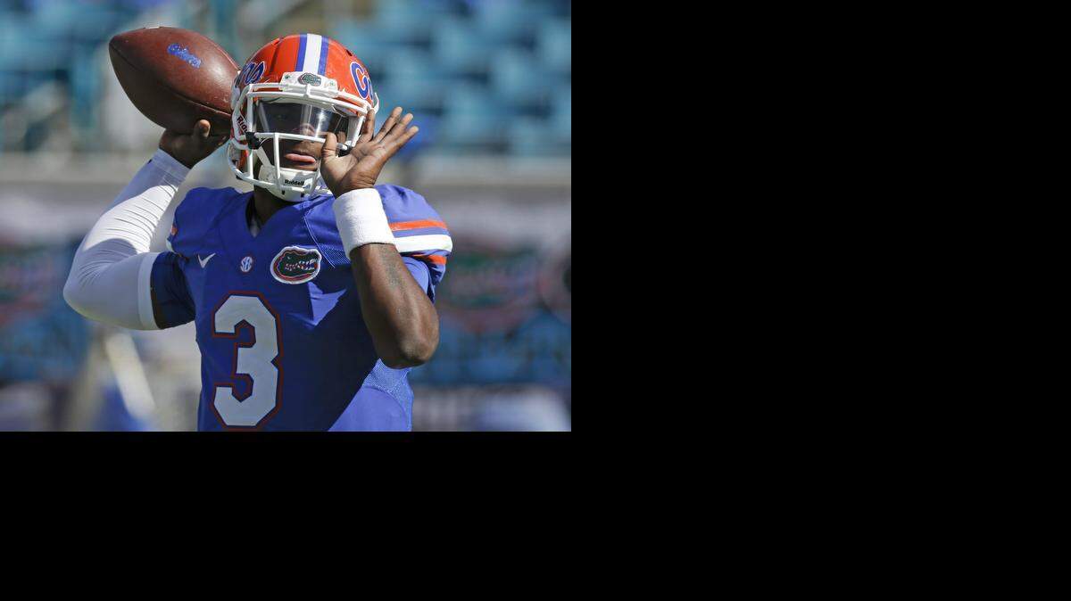 
Florida quarterback Treon Harris (3) warms up before a game against Georgia in Jacksonville, Fla., Saturday, Nov. 1, 2014. 
