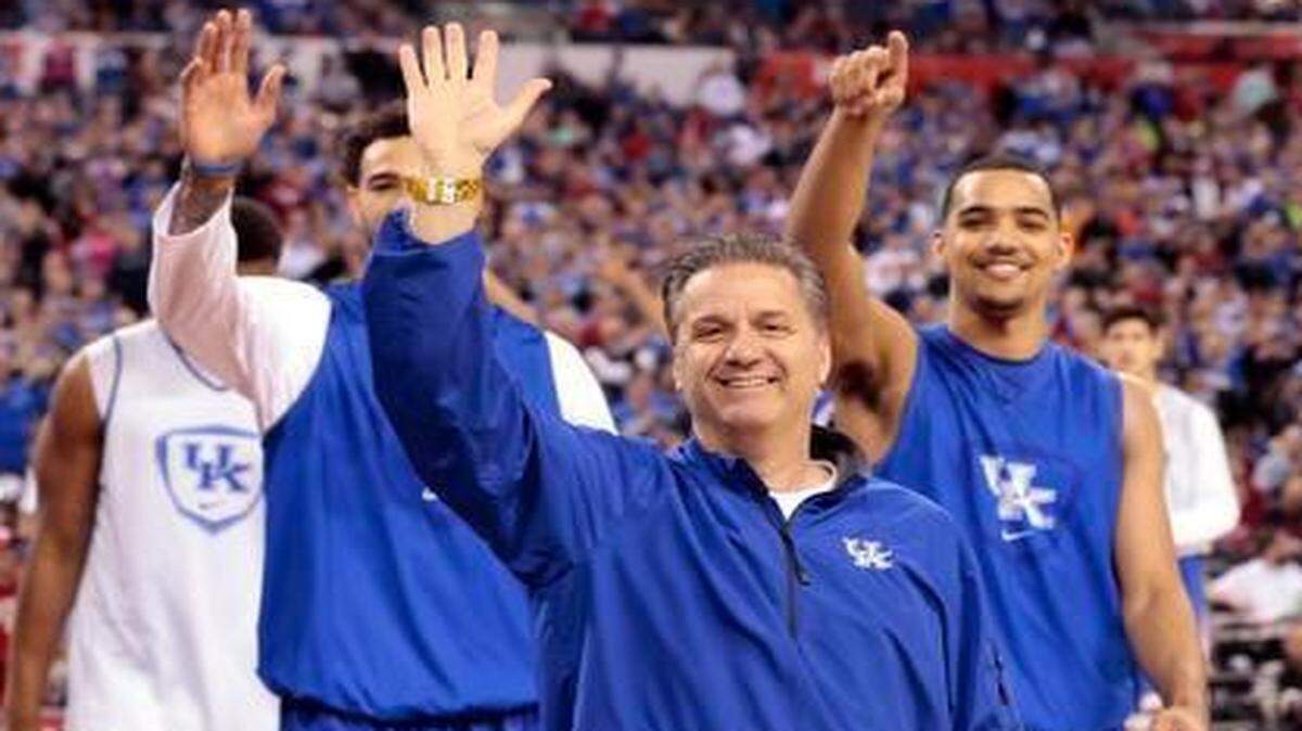 
The University of Kentucky basketball team, led by head coach John Calipari, walks around the floor waving to fans as they conclude practice at Lucas Oil Stadium in Indianapolis on Friday, April 3, 2015. 
