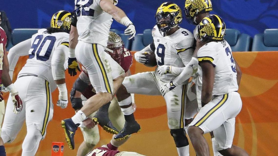 Michigan Wolverines linebacker Mike McCray (9) celebrates after scoring on an interception in the third quarter during the  Orange Bowl game between Michigan and FSU on Fri., Dec. 30, 2016. The Dolphins signed McCray after the draft.