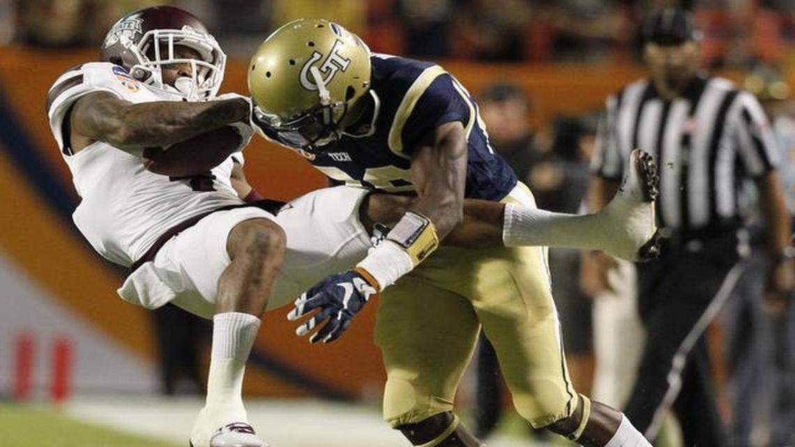 
Mississippi State Bulldogs wide receiver Jameon Lewis (4) ) is hit hard by Georgia Tech Yellow Jackets defensive back D.J. White (28) in the first quarter. Mississippi State vs Georgia Tech at the 2014 Orange Bowl Game at Sun Life Stadium on Wednesday, December 31, 2014.
