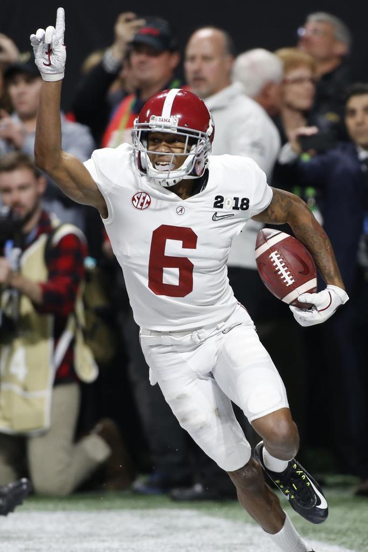Alabama wide receiver DeVonta Smith (6) celebrates after making the game winning catch off a pass from Alabama quarterback Tua Tagovailoa (13) in overtime of the NCAA Championship game between Georgia and Alabama in Atlanta on Monday, Jan. 8, 2018.