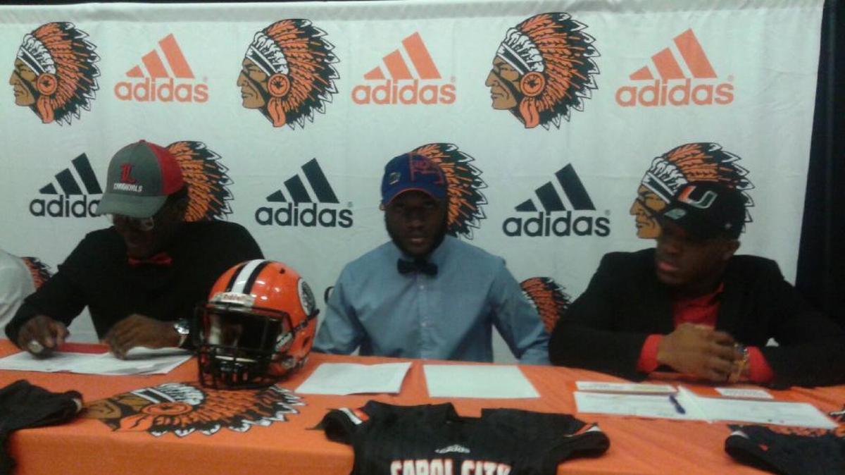 Carol City’s Randy Russell signs with the Florida Gators on Wednesday.
