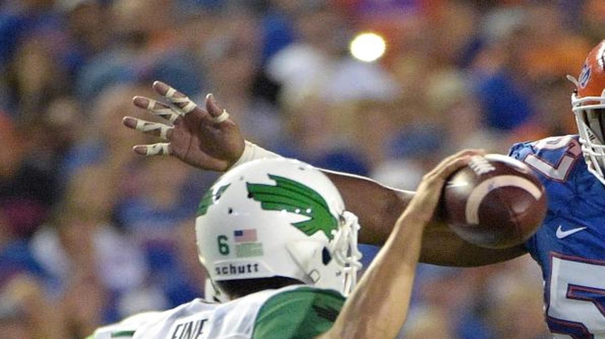 Florida defensive lineman Caleb Brantley (57) pressures North Texas quarterback Mason Fine (6) during the first half of an NCAA college football game in Gainesville, Fla., Saturday, Sept. 17, 2016.