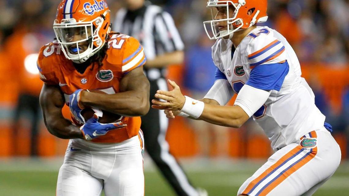 Former University School and St. Thomas Aquinas running back Jordan Scarlett takes a hand off from quarterback Feleipe Franks during the Florida Gators’ spring game. Scarlett is one of nine players suspended for a credit card scam.