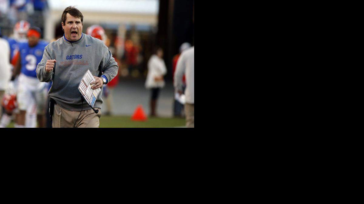 
Florida coach Will Muschamp coaches from the sideline against Georgia in Jacksonville, Fla., Saturday, Nov. 1, 2014. 
