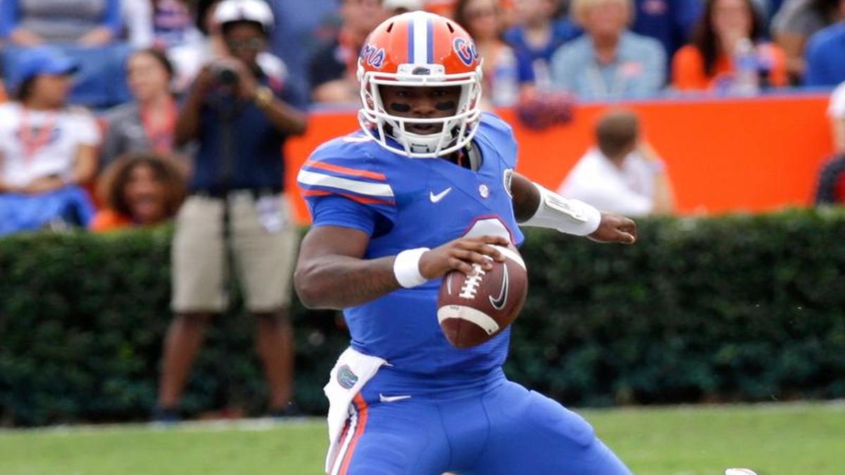 Florida quarterback Treon Harris (3) is runs out of bounds by Florida Atlantic running back Greg Howell, bottom, during the first half of an NCAA college football game, Saturday, Nov. 21, 2015, in Gainesville, Fla.