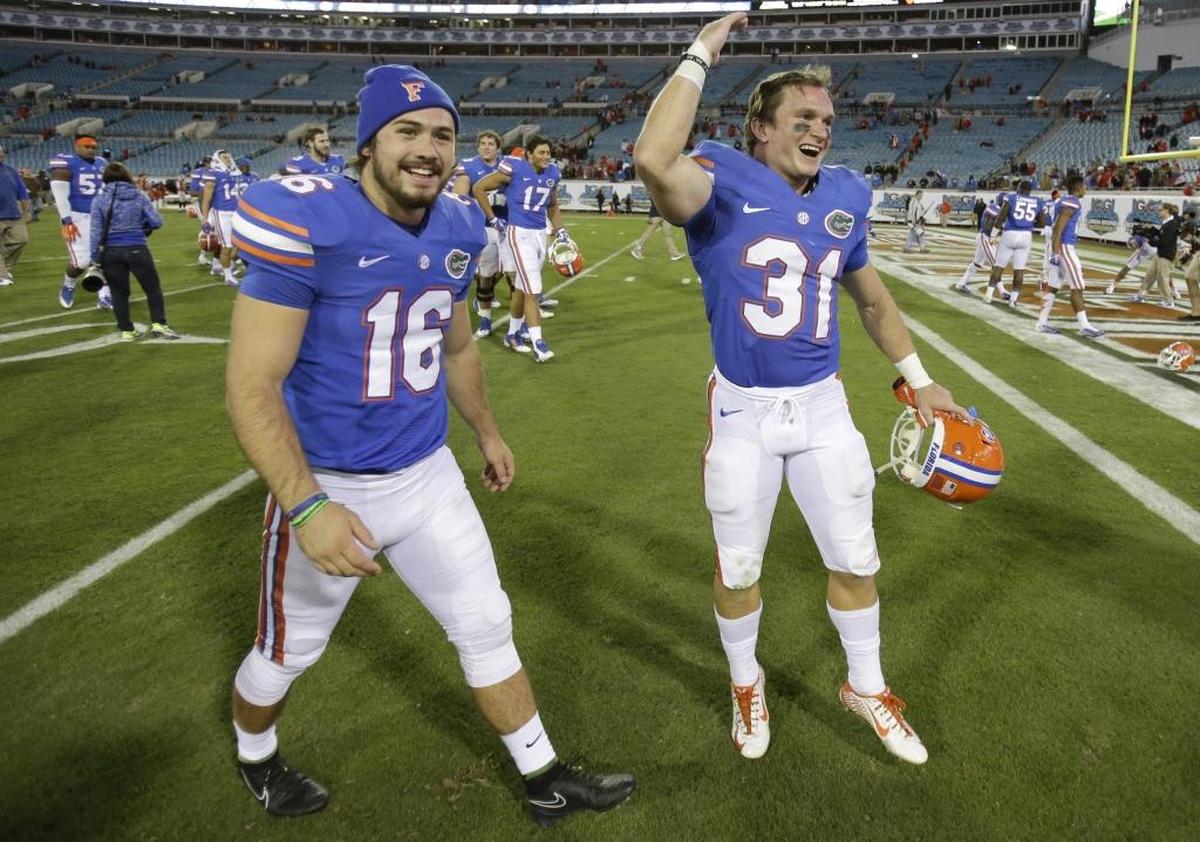 Florida place kicker Austin Hardin (16) and Michael McNeely (31) celebrate on the field after defeating Georgia 38-20 in an NCAA college football game in Jacksonville, Fla., Sat., Nov. 1, 2014. Florida won 38-20.