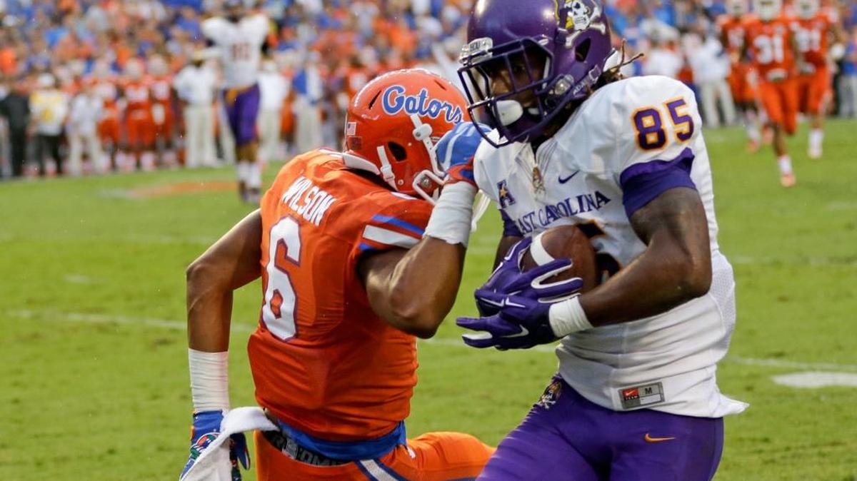 
East Carolina wide receiver Davon Grayson catches a pass in front of Florida defensive back Quincy Wilson to score a 31-yard touchdown Saturday, Sept. 12, 2015, in Gainesville, Fla. 
