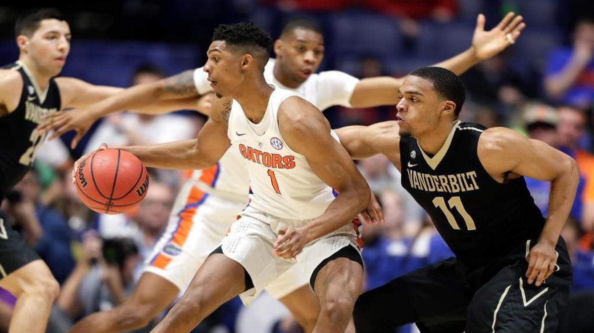 Florida forward Devin Robinson (1) is defended by Vanderbilt forward Jeff Roberson (11) during the second half of an NCAA college basketball game at the Southeastern Conference tournament Fri., March 10, 2017, in Nashville, Tenn. Vanderbilt upset Florida in overtime 72-62.