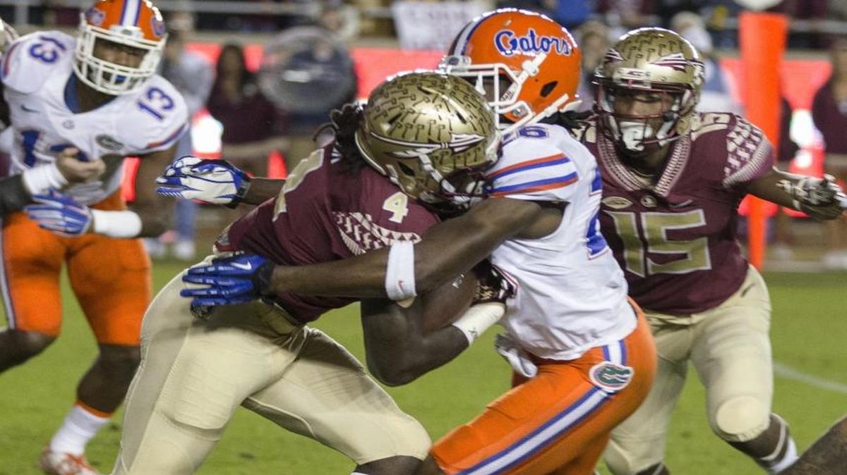 Florida State running back Dalvin Cook runs into Florida defensive back Marcell Harris during the first quarter of an NCAA college football game in Tallahassee, Fla., Sat., Nov. 26, 2016.