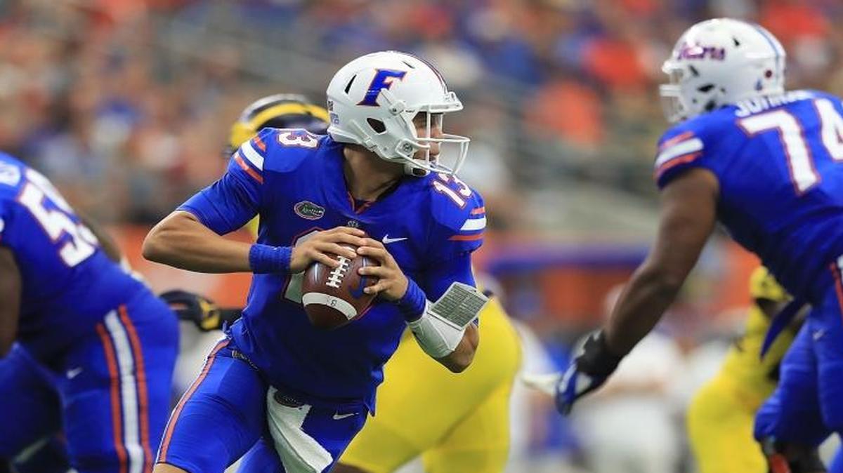 Feleipe Franks (13) of the Florida Gators scramble in the pocket against the Michigan Wolverines in the first half of a game at AT&T Stadium on September 2, 2017 in Arlington, Texas.
