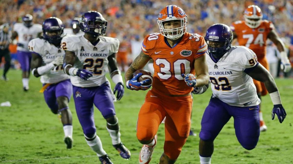 
Florida tight end DeAndre Goolsby (30) runs past East Carolina nose tackle Mike Myers (92) and defensive back Terrell Richardson (22) for a touchdown on a 32-yard pass play during the first half of an NCAA college football game, Saturday, Sept. 12, 2015, in Gainesville, Fla. 
