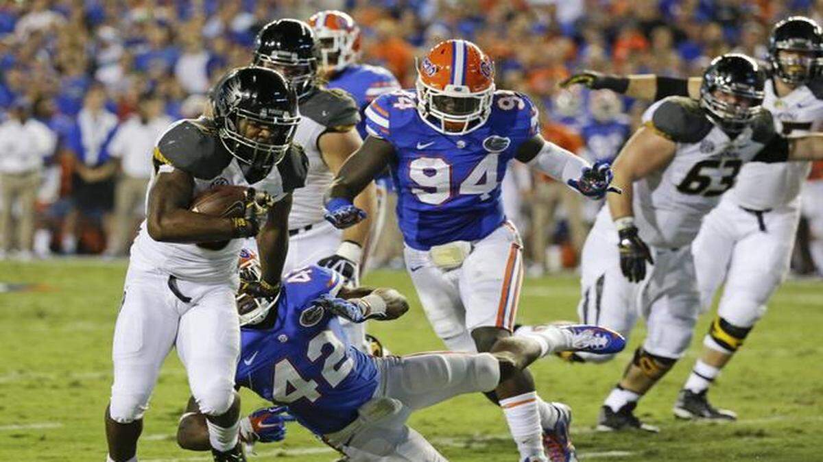 Unstoppable:  Missouri’s Marcus Murphy, left, runs past past Florida defensive back Keanu Neal (42) and defensive lineman Bryan Cox Jr. (94) for a 5-yard touchdown in Saturday’s blowout.