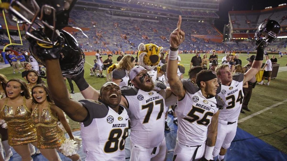 
Missouri's Jimmie Hunt (88), Evan Boehm (77), Shane Ray (56) and Joey Burkett (34) celebrate in front of fans after Missouri defeated Florida 42-13 in an NCAA college football game in Gainesville, Fla., Saturday, Oct. 18, 2014.
