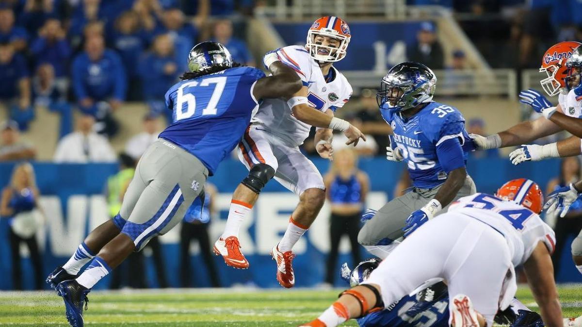 
Florida quarterback Will Grier is hit by Kentucky defensive tackle Cory Johnson, left, after throwing a pass during the first half of an NCAA college football game, Saturday, Sept. 19, 2015, in Lexington, Ky. 
