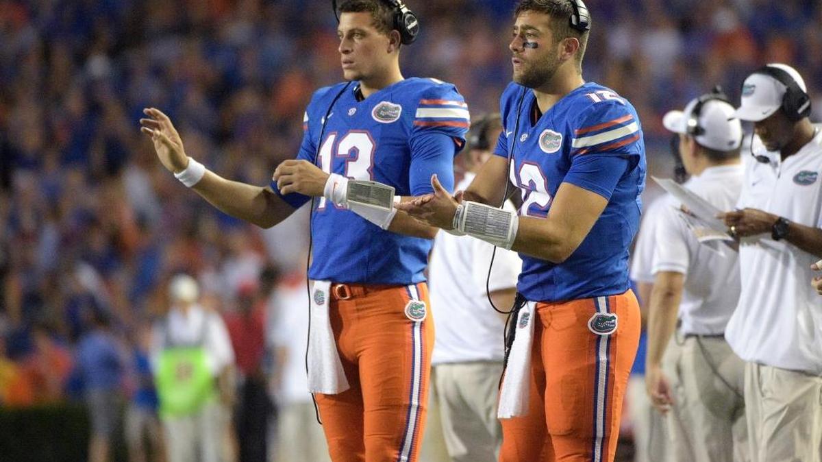 Florida quarterback Austin Appleby (12) and quarterback Feleipe Franks (13) signal in a play from the sideline during the first half of a game against North Texas on Sept. 17, 2016.