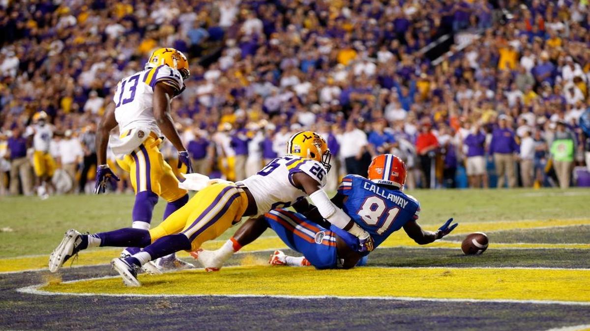 Florida wide receiver Antonio Callaway (81) drops a pass in the end zone under pressure from LSU defensive back Dwayne Thomas (13) and safety John Battle (26) in the second half of an NCAA college football game in Baton Rouge, La., Sat., Oct. 17, 2015. LSU won 35-28.