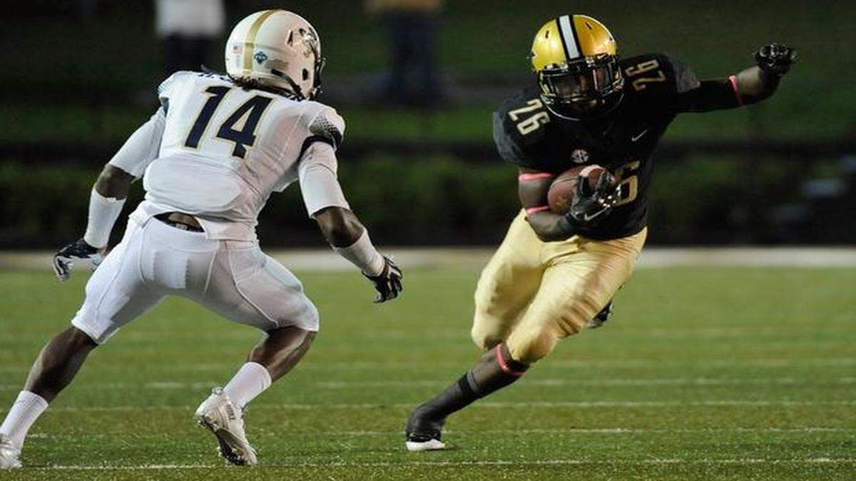 
Ralph Webb of Vanderbilt carries the ball as Malcolm Jackson of Charleston Southern defends at Vanderbilt Stadium on October 11, 2014 in Nashville, Tennessee. 
