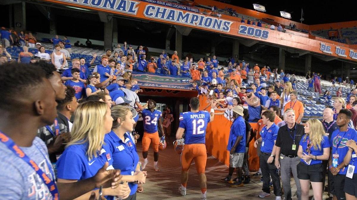 Florida quarterback Austin Appleby (12) high-fives fans after an NCAA college football game against North Texas in Gainesville, Fla., Saturday, Sept. 17, 2016. Florida won 32-0.