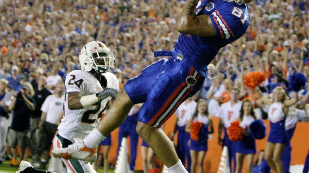 Florida tight end Aaron Hernandez pulls in a touchdown pass over Miami's Chavez Grant at Florida Field in 2008.