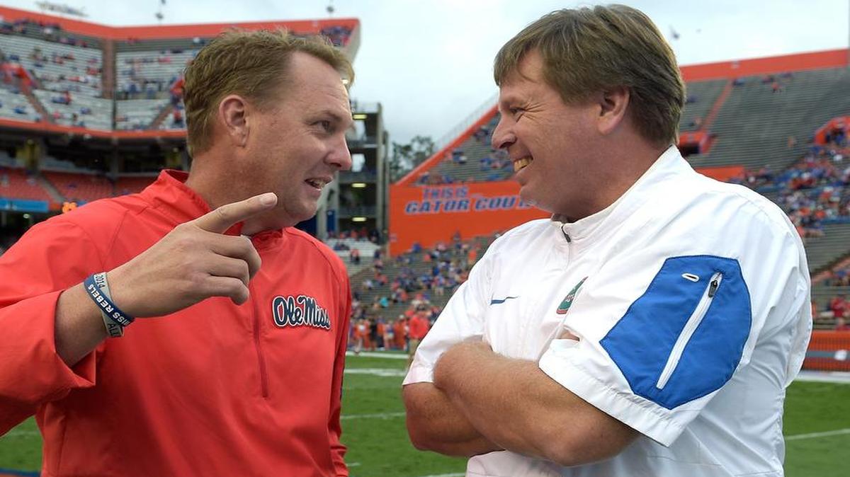 Florida coach Jim McElwain, right, chats with Ole Miss Hugh Freeze before the Gators took control of the SEC East with an upset of the Rebels on Saturday night.