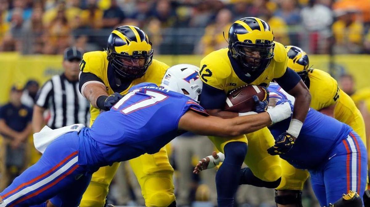 Florida defensive lineman Jordan Sherit (17) attempts to stop Michigan running back Chris Evans (12) from advancing the run in the first half of an NCAA college football game, Saturday, Sept. 2, 2017, in Arlington, Texas.