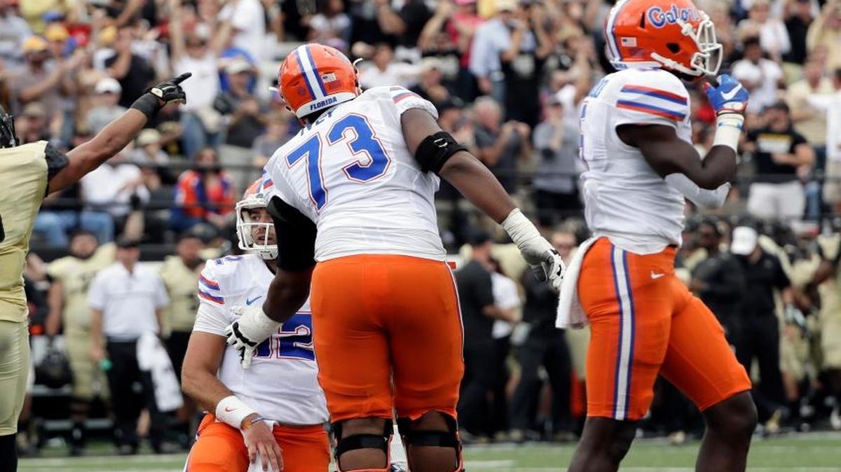 Florida quarterback Austin Appleby (12) is helped up by offensive lineman Martez Ivey (73) after Appleby fumbled against Vanderbilt in the second half of an NCAA college football game Saturday, Oct. 1, 2016, in Nashville, Tenn. Florida won 13-6.