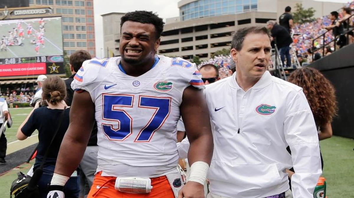Florida defensive lineman Caleb Brantley (57) is led off the field after being injured in the second half of an NCAA college football game against Vanderbilt Saturday, Oct. 1, 2016, in Nashville, Tenn. Florida won 13-6.