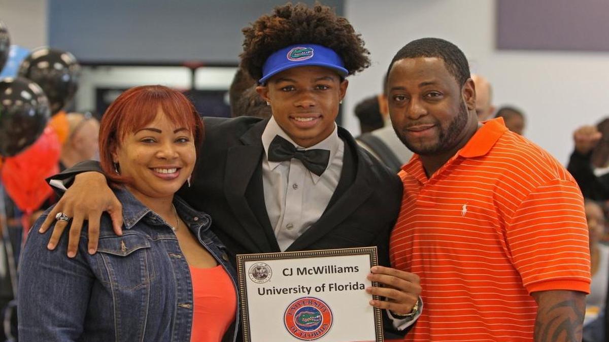 Christopher “C.J.” McWilliams of Southwest Miami High poses with mom Kimone Fance and stepfather Ell Fance after signing with the University of Florida on National Signing Day on Wednesday, Feb., 3, 2016.