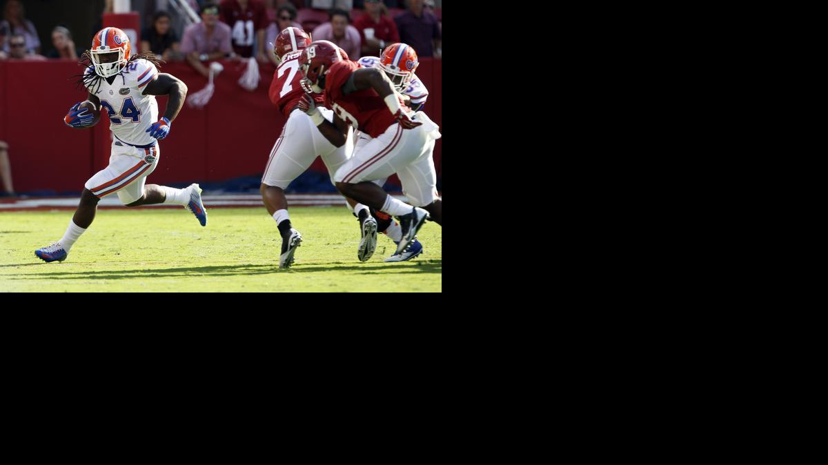 
Florida running back Matt Jones (24) tries to get to the outside as he carries the ball during the first half of an NCAA college football game against Alabama on Saturday, Sept. 20, 2014, in Tuscaloosa, Ala. 
