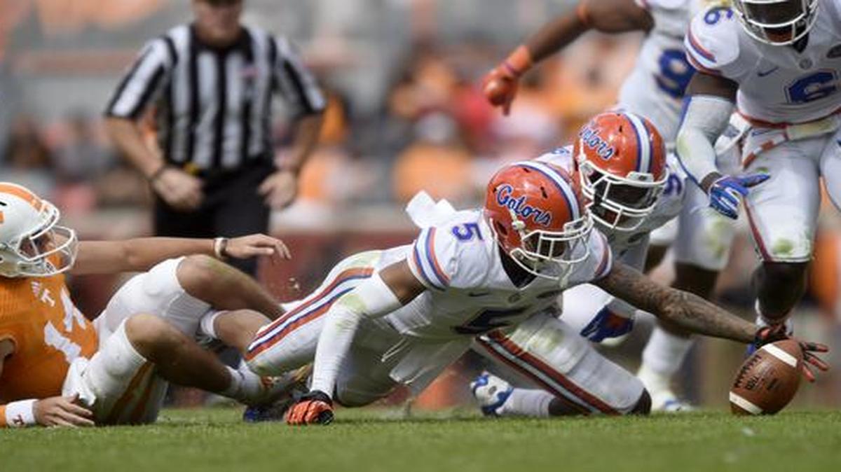 
Florida defensive back Jalen Tabor (5) recovers a fable by Tennessee quarterback Justin Worley (14) during the second half of an NCAA college football game at Neyland Stadium, Saturday, Oct. 4, 2014, in Knoxville, Tenn. 
