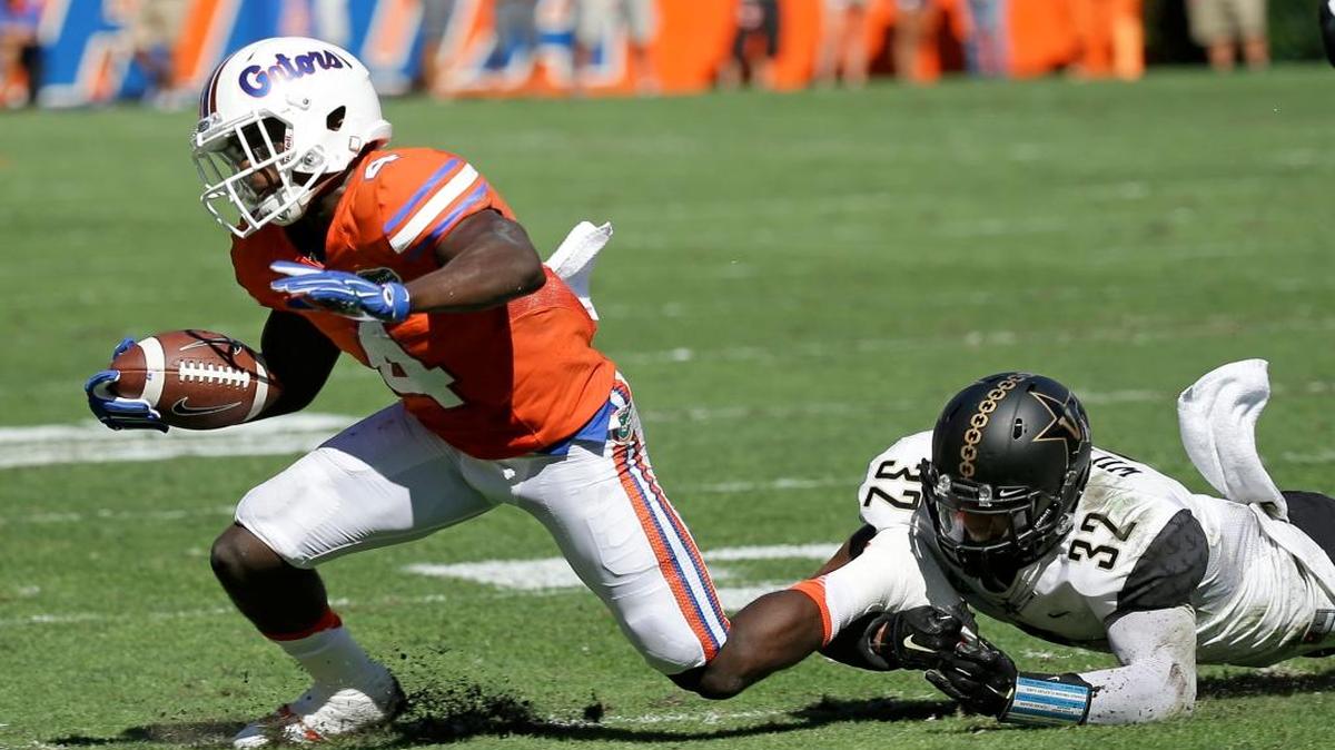 Florida wide receiver Brandon Powell (4) is stopped by Vanderbilt safety Andrew Williamson (32) after a short gain during the first half of an NCAA college football game, Saturday, Nov. 7, 2015, in Gainesville, Fla.