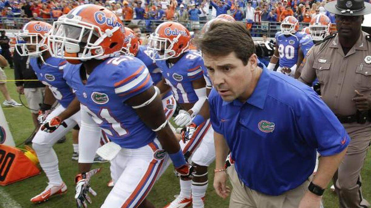 
Florida head coach Will Muschamp leads his team out on the field against Georgia in Jacksonville, Fla., Saturday, Nov. 2, 2013
