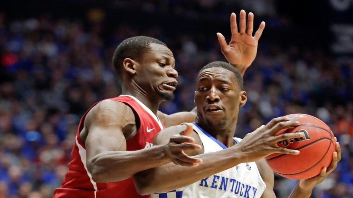 Arkansas forward Moses Kingsley, left, pressures Kentucky forward Edrice Adebayo (3) in the first half of an NCAA college basketball game for the championship of the Southeastern Conference tournament Sunday, March 12, 2017, in Nashville, Tenn.