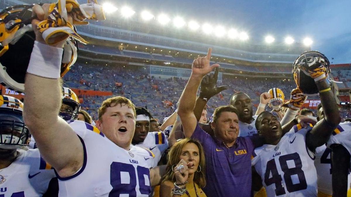 LSU wide receiver Jonathan Giles (89) and linebacker Donnie Alexander (48) celebrate a 17-16 victory against Florida with LSU coach Ed Orgeron, second from right, and his wife Kelly Orgeron after an NCAA college football game on Saturday, Oct. 7, 2017, in Gainesville, Florida.